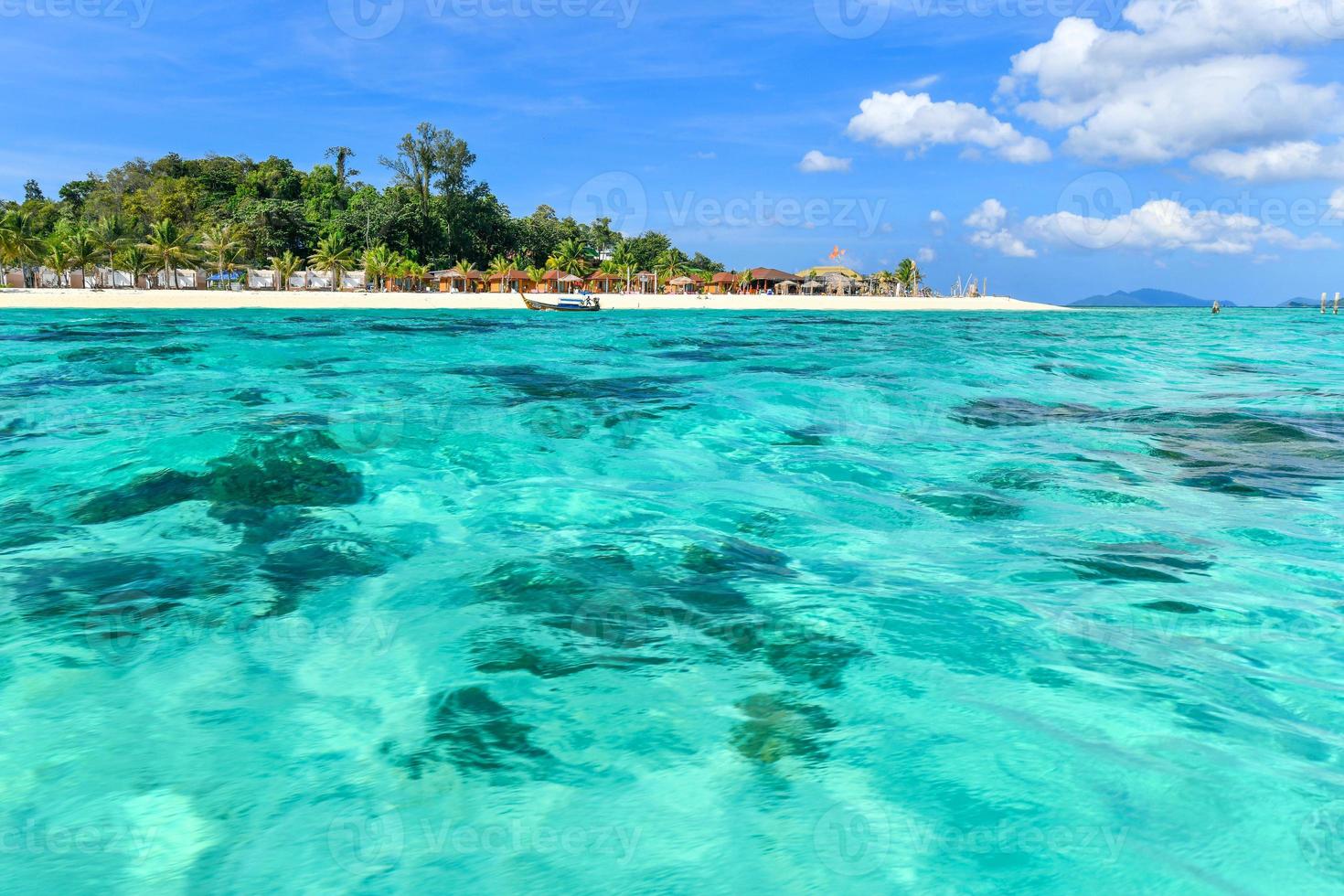 Pure white sand in front of beach resorts and a calm turquoise blue crystal clear sea Ko Lipe, Thailand photo
