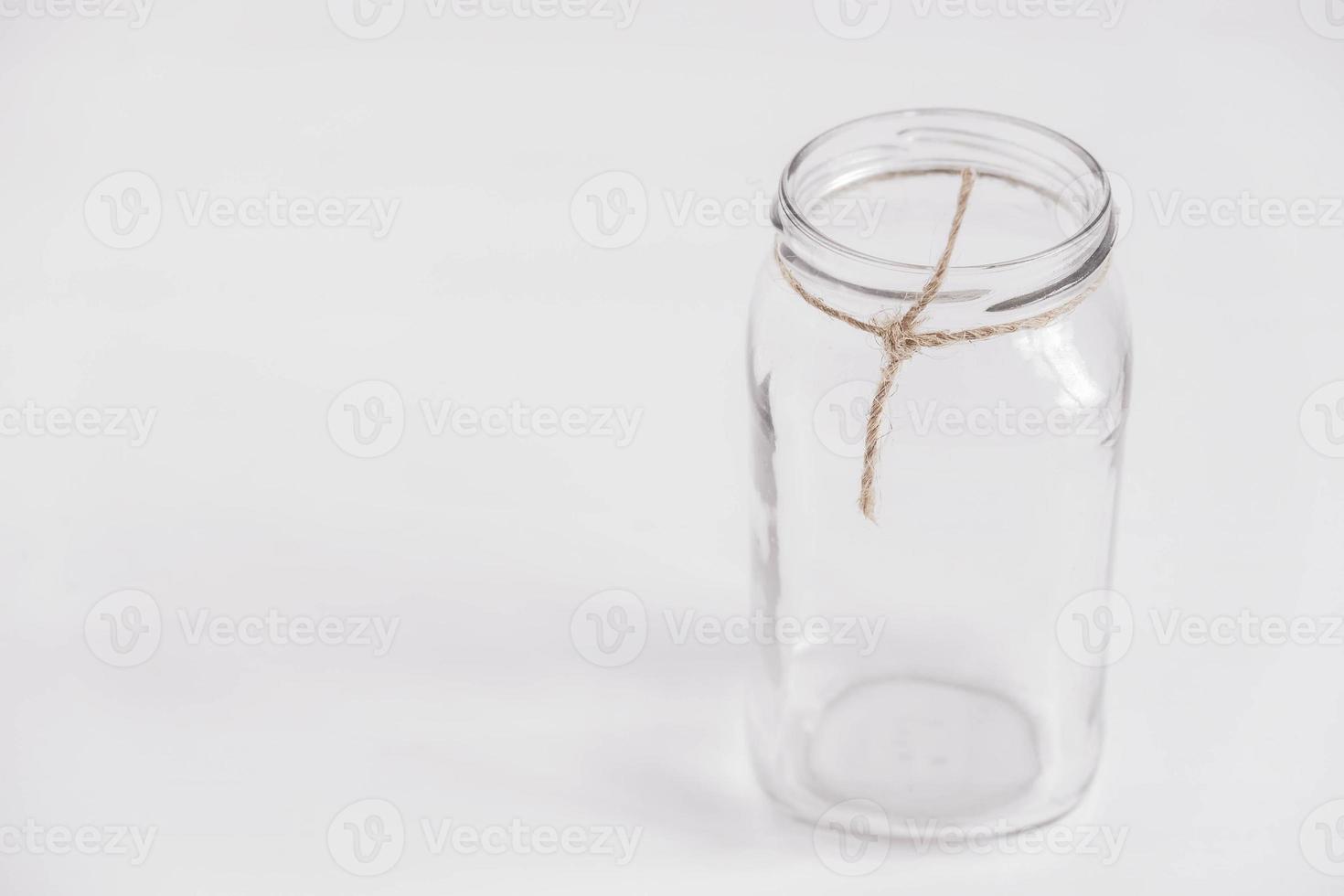 Glass transparent jar on a white table background. Copy, empty space for text photo