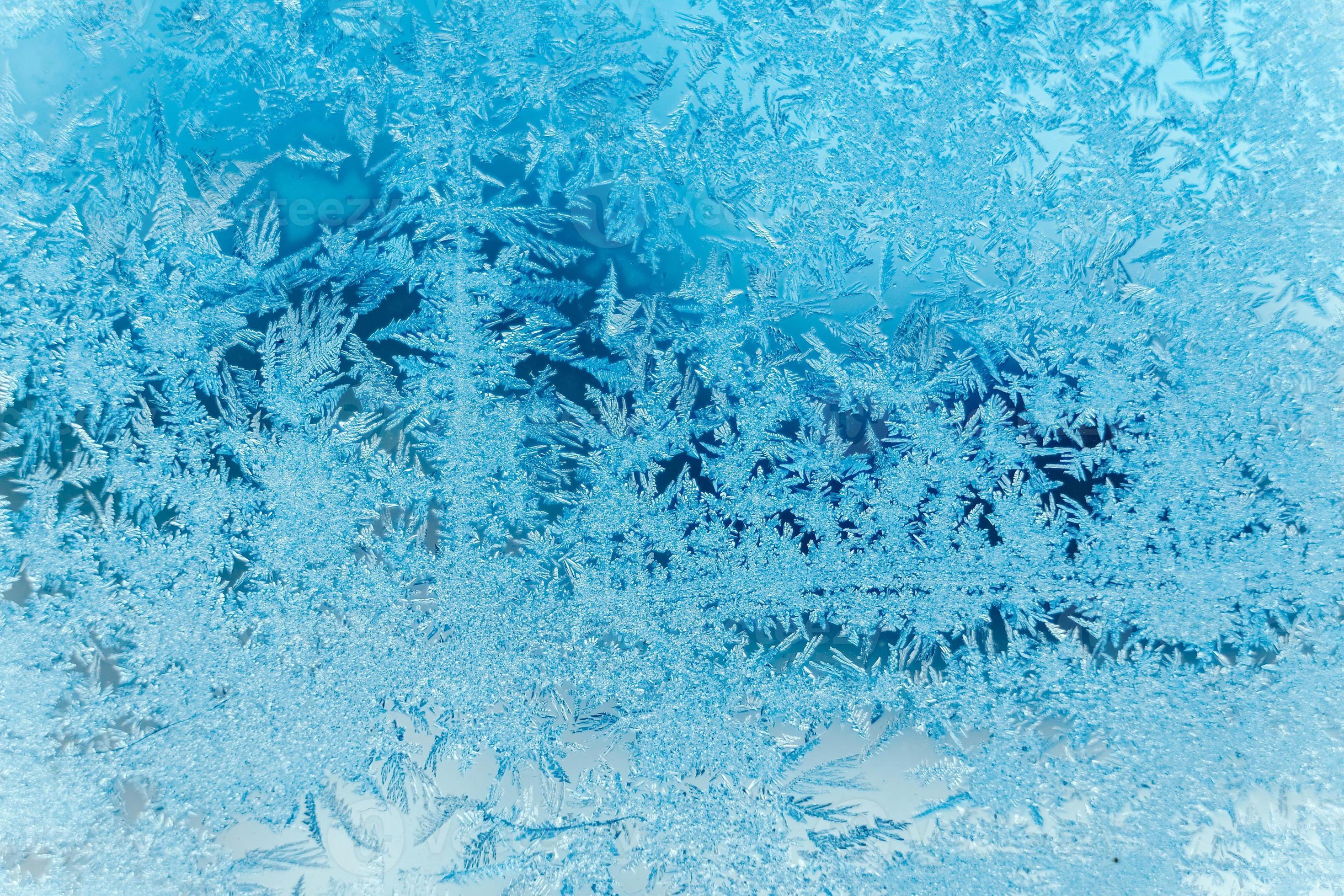 Ice patterns on frozen glass. Abstract ice pattern on winter glass as a