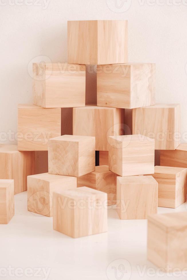 Stack wooden blocks from natural wood on a white background. Copy, empty space for text photo