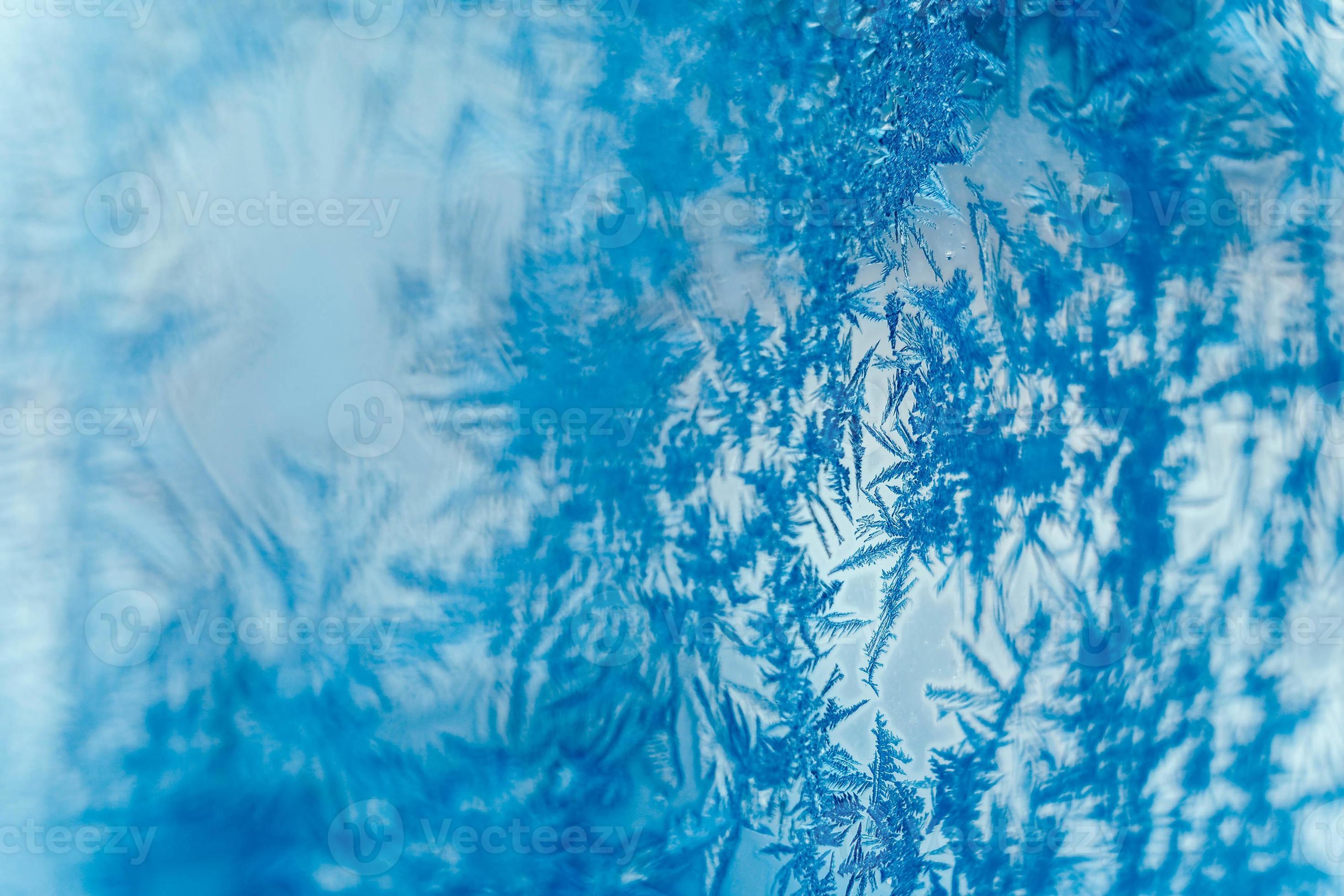 Ice patterns on frozen glass. Abstract ice pattern on winter glass as a
