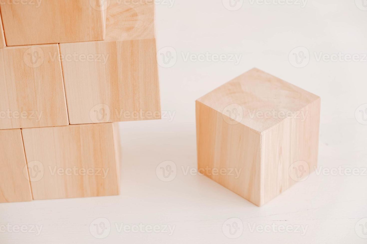 Stack wooden blocks from natural wood on a white background. Copy, empty space for text photo