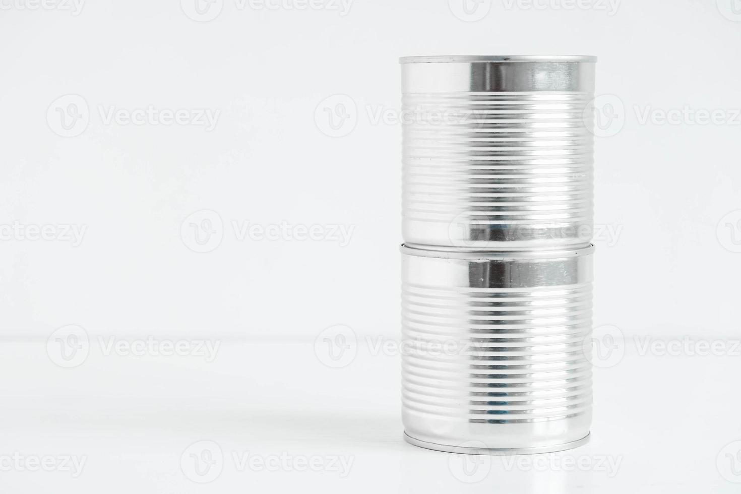 Two aluminum closed metal cans on a white table. Copy, empty space for text photo