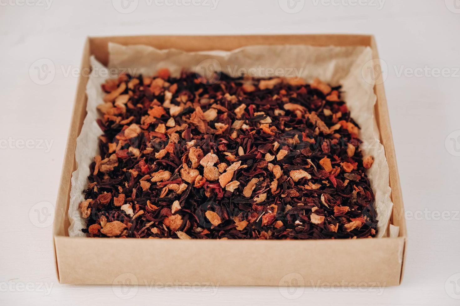 Dry fruit tea in a paper box on a white table background. Copy, empty space for text photo