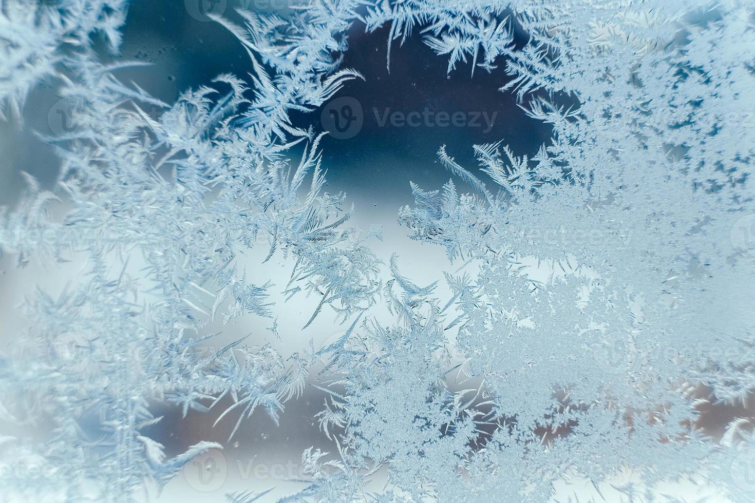 Ice patterns on frozen glass. Abstract ice pattern on winter glass as a background image photo