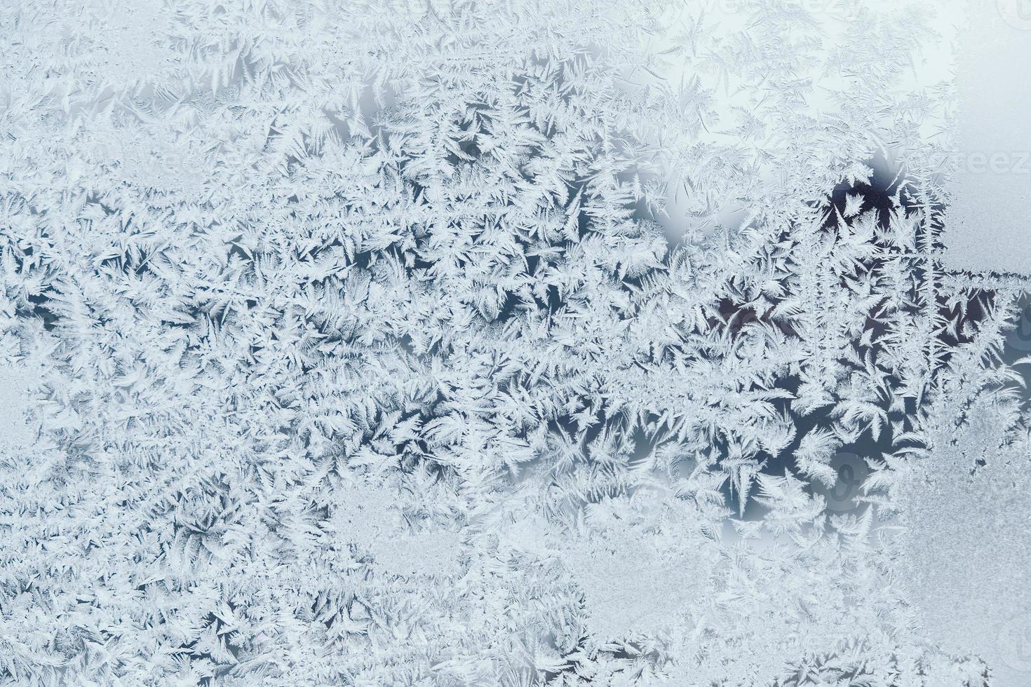 Ice patterns on frozen glass. Abstract ice pattern on winter glass as a background image photo