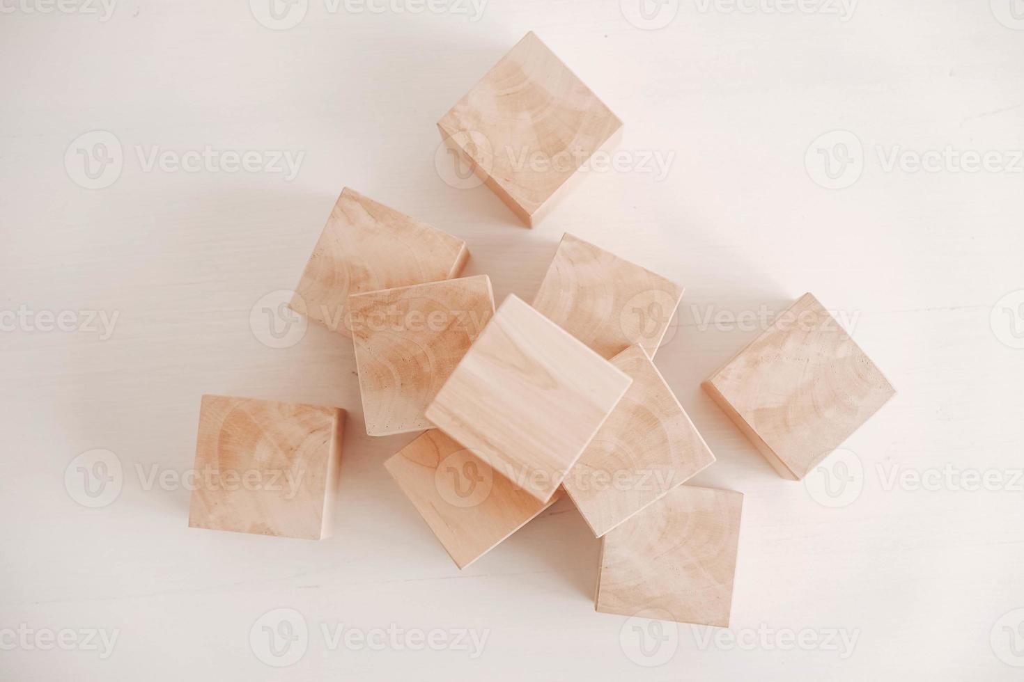 Stack wooden blocks from natural wood on a white background. Top view. Copy, empty space for text photo