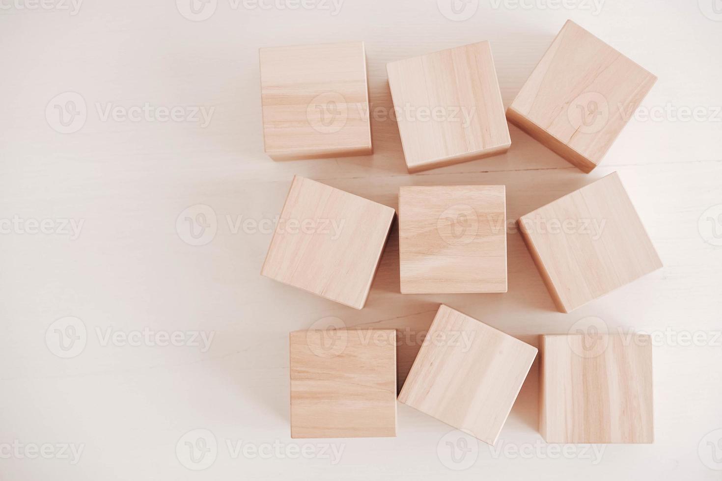 Wooden cubes from natural wood on a white background. Top view. Copy, empty space for text photo