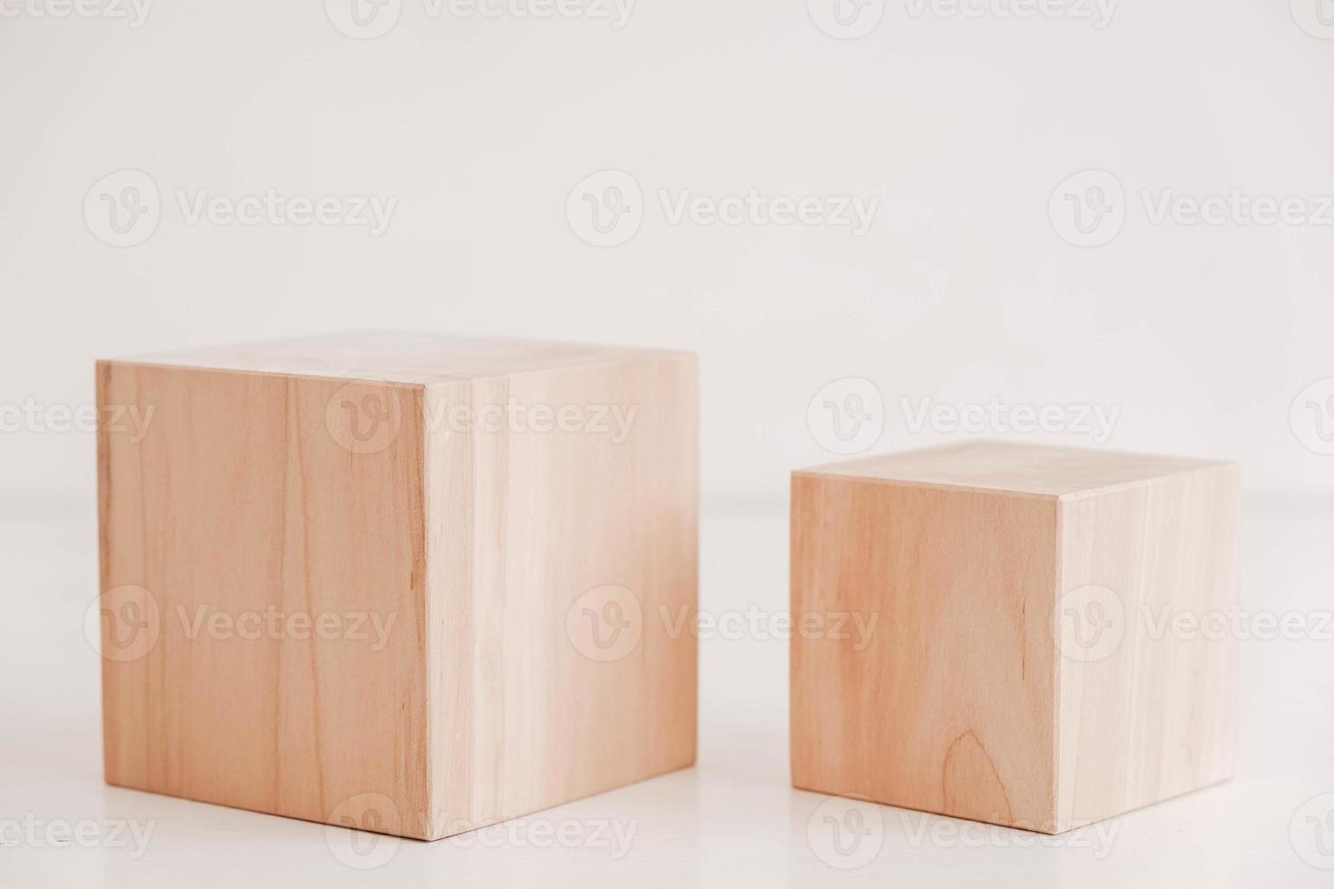 Two wooden blocks from natural wood on a white background. Copy, empty space for text photo
