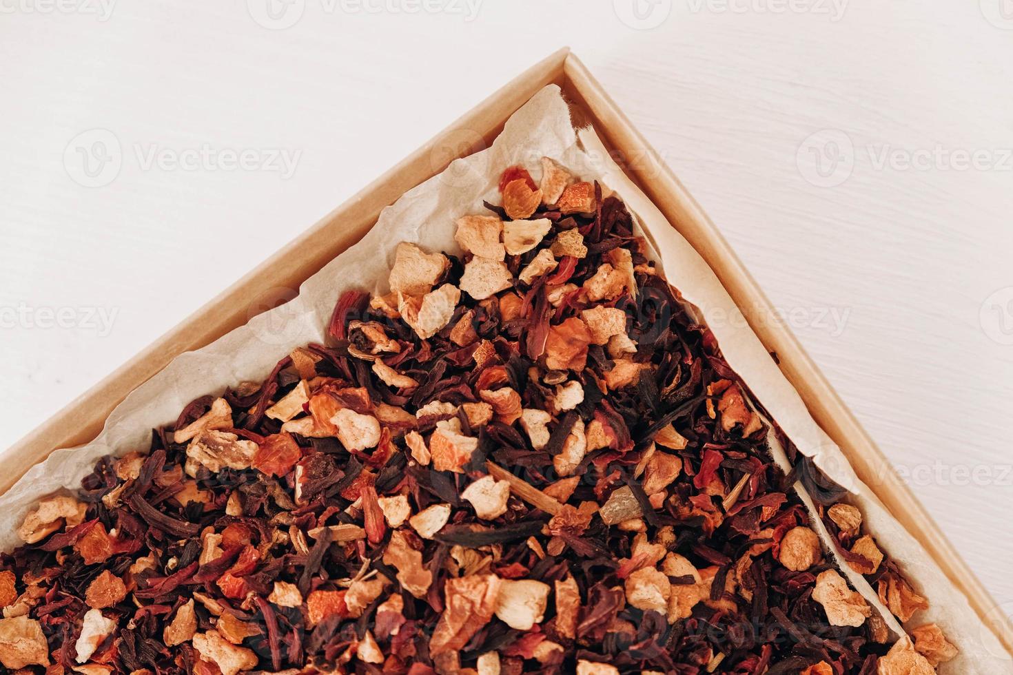 Dry fruit tea in a paper box on a white table background. Top view. Copy, empty space for text photo