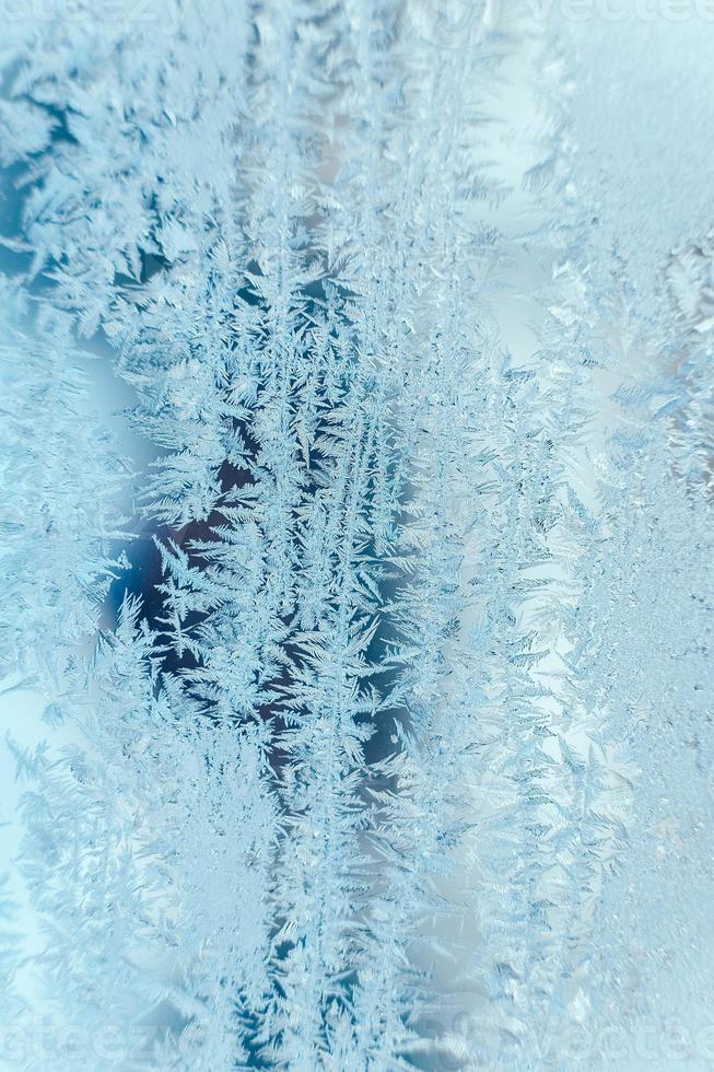 Ice patterns on frozen glass. Abstract ice pattern on winter glass as a background image. Copy, empty space for text photo