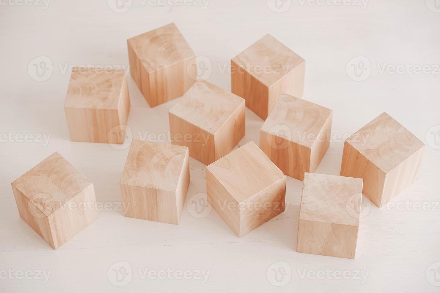 Wooden cubes from natural wood on a white background. Copy, empty space for text photo