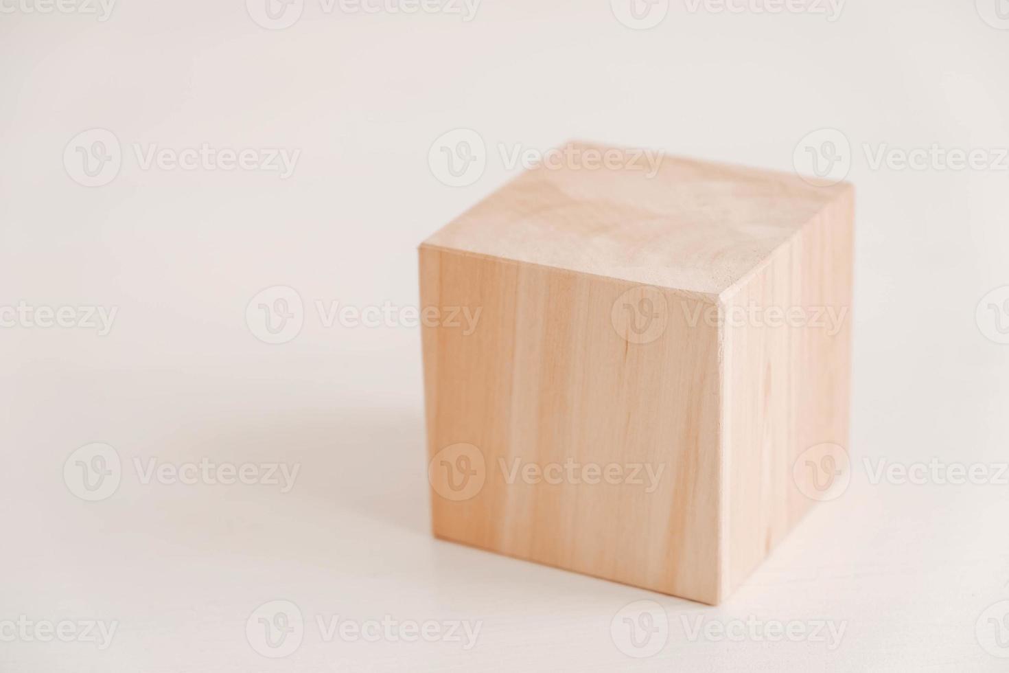 Wooden cube from natural wood on a white background. Copy, empty space for text photo