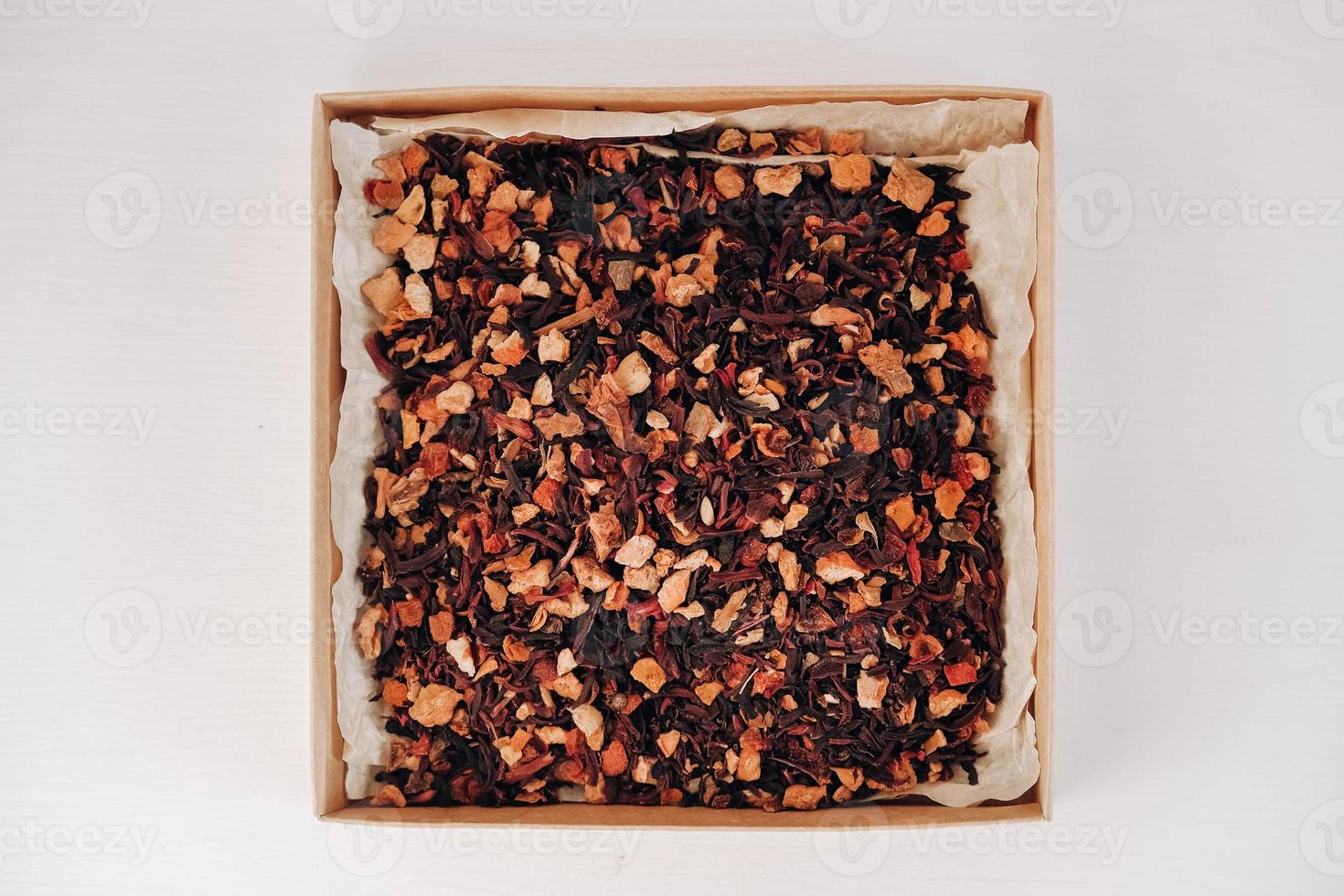 Dry fruit tea in a paper box on a white table background. Top view. Copy, empty space for text photo