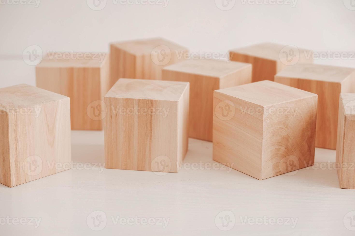 Wooden cubes from natural wood on a white background. Copy, empty space for text photo