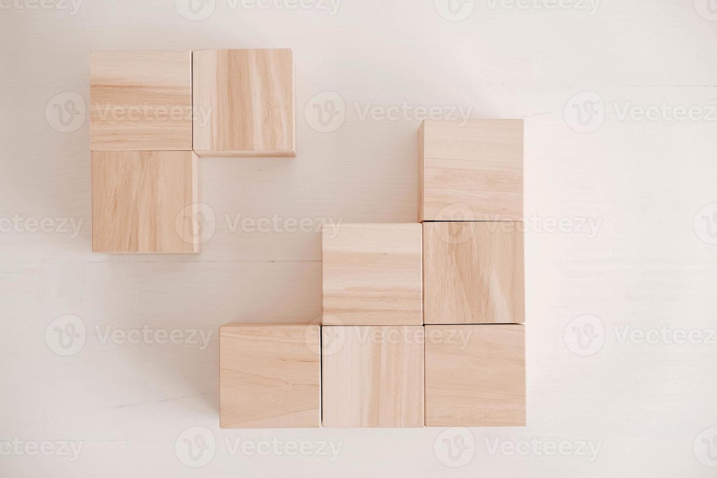 Stack wooden blocks from natural wood on a white background. Top view. Copy, empty space for text photo