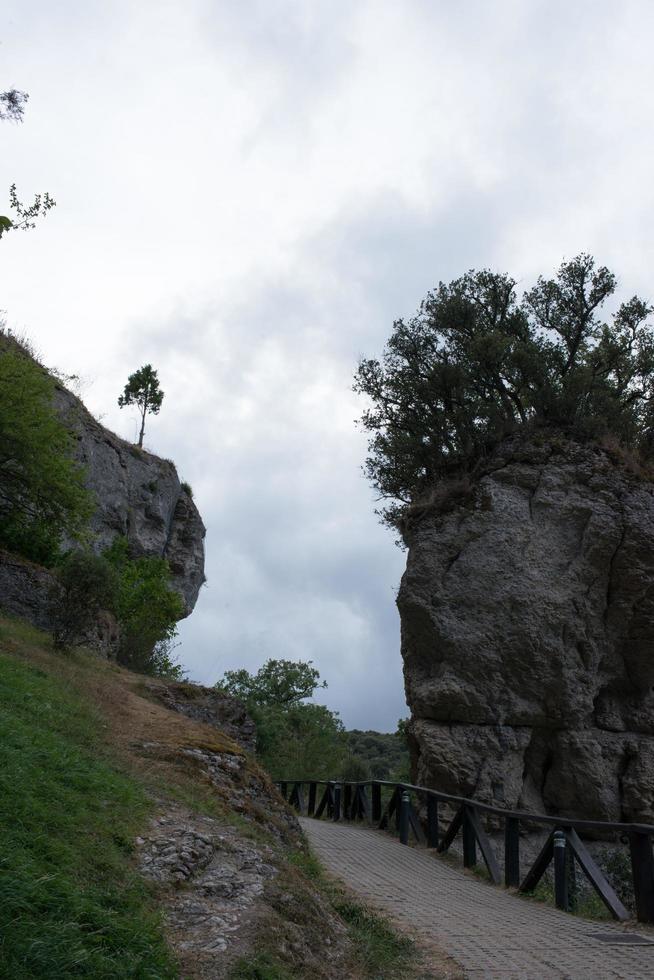 Beautiful pathway for walking in the nature. Rocks and green areas. Burgos, Merindades, Spain photo