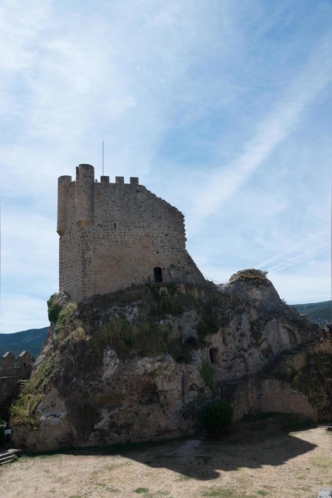 Beautiful view from below of ancient castle at Frias with blue sky. Burgos, Merindades, Spain photo
