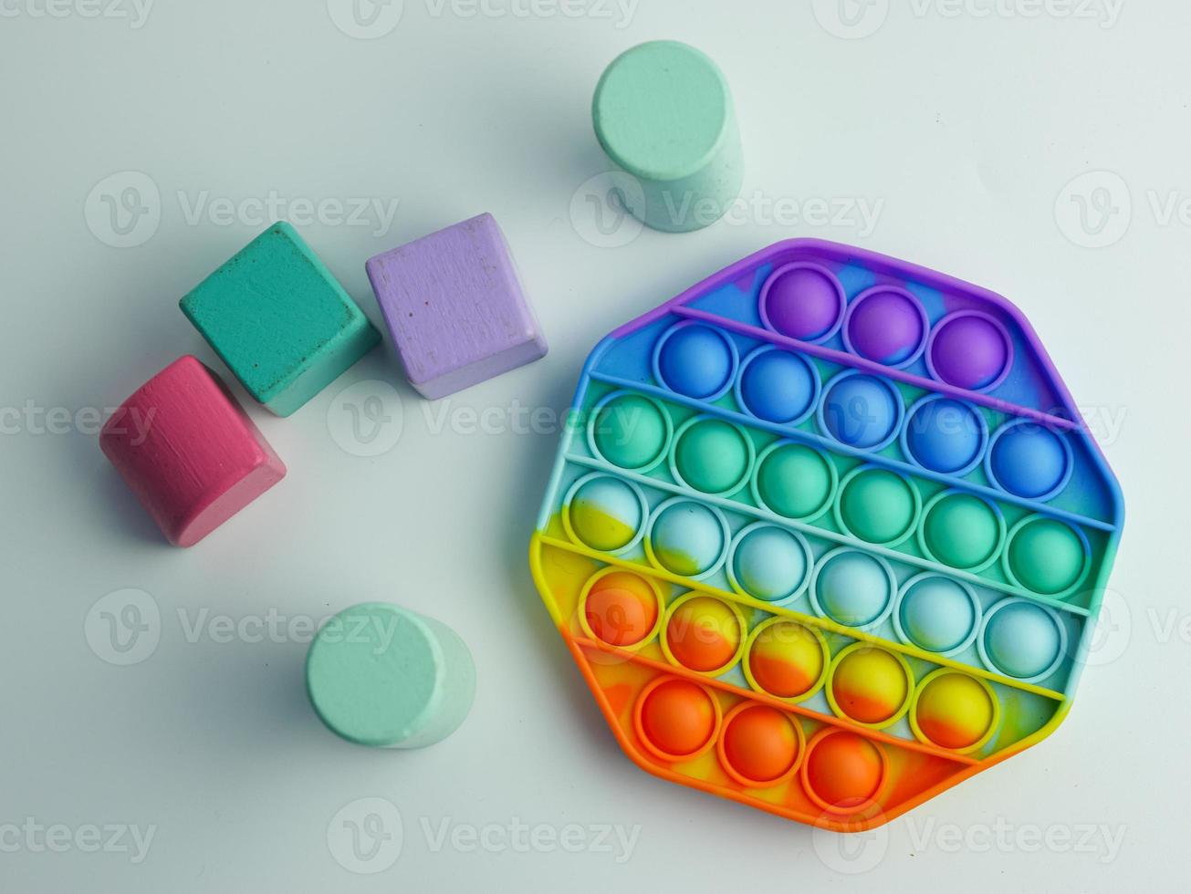 hexagon pop it fidget toy and colorful cube blocks photo