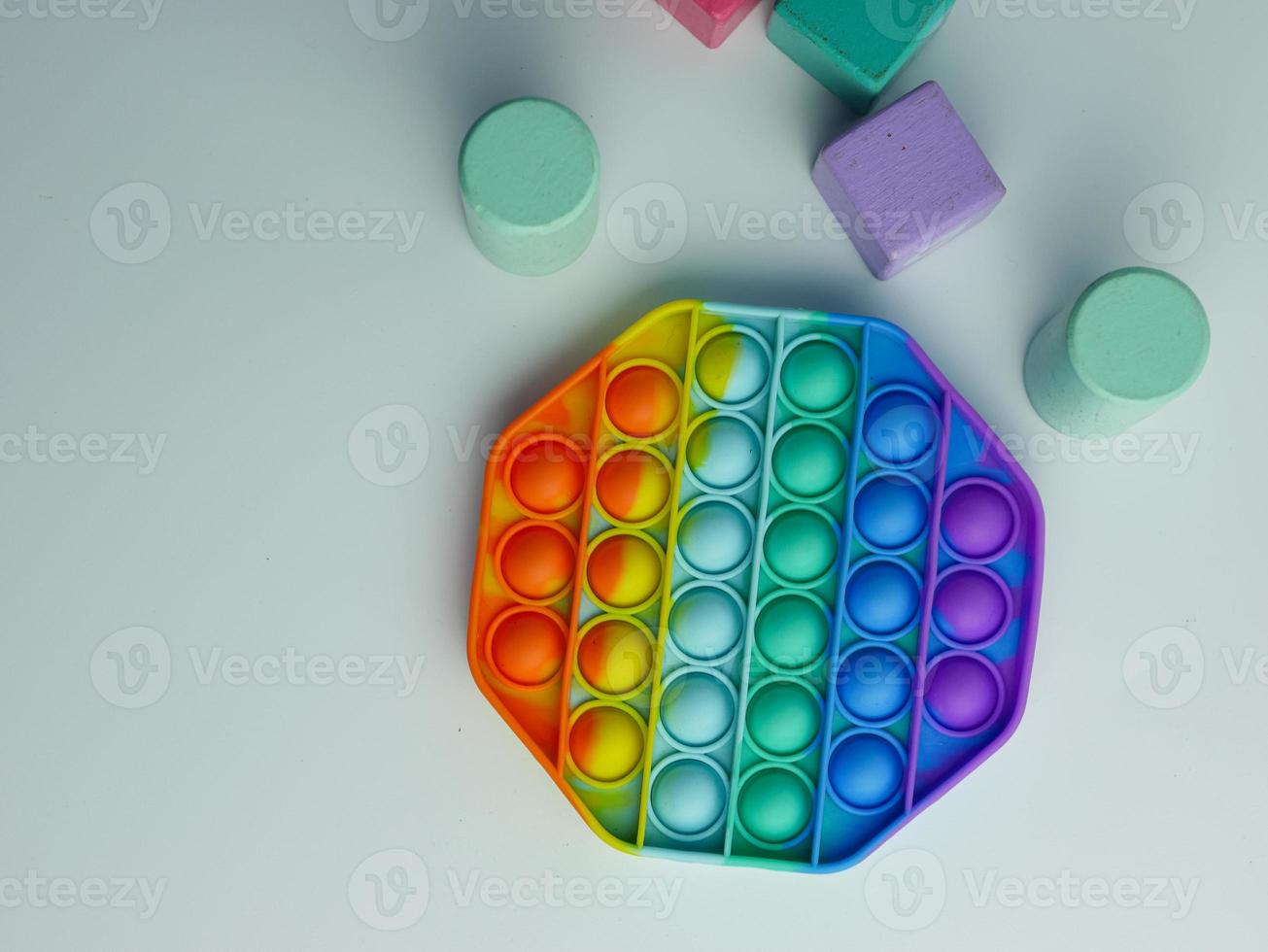 hexagon pop it fidget toy and colorful cube blocks photo