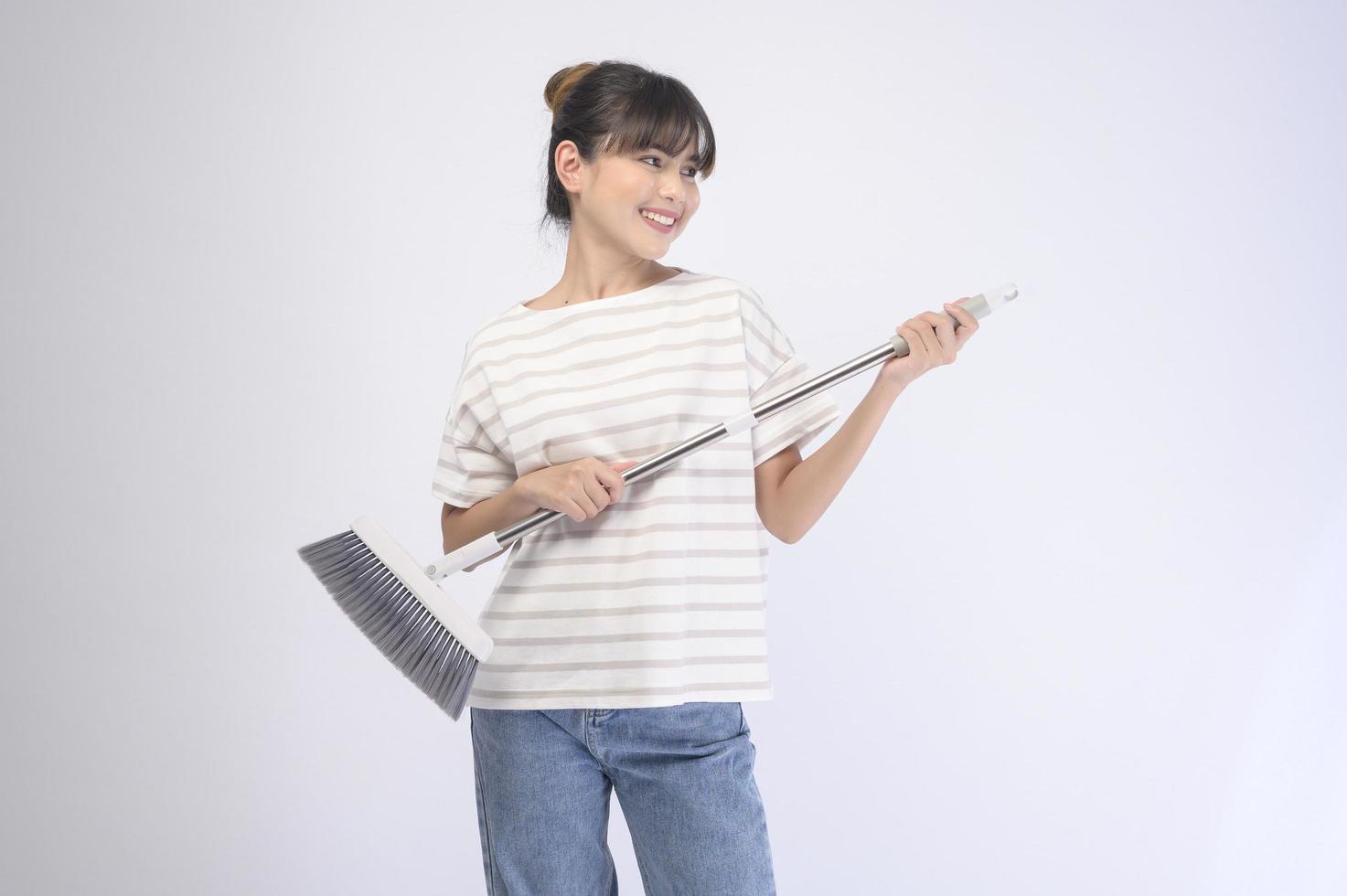Young beautiful housewife smiling on white background photo