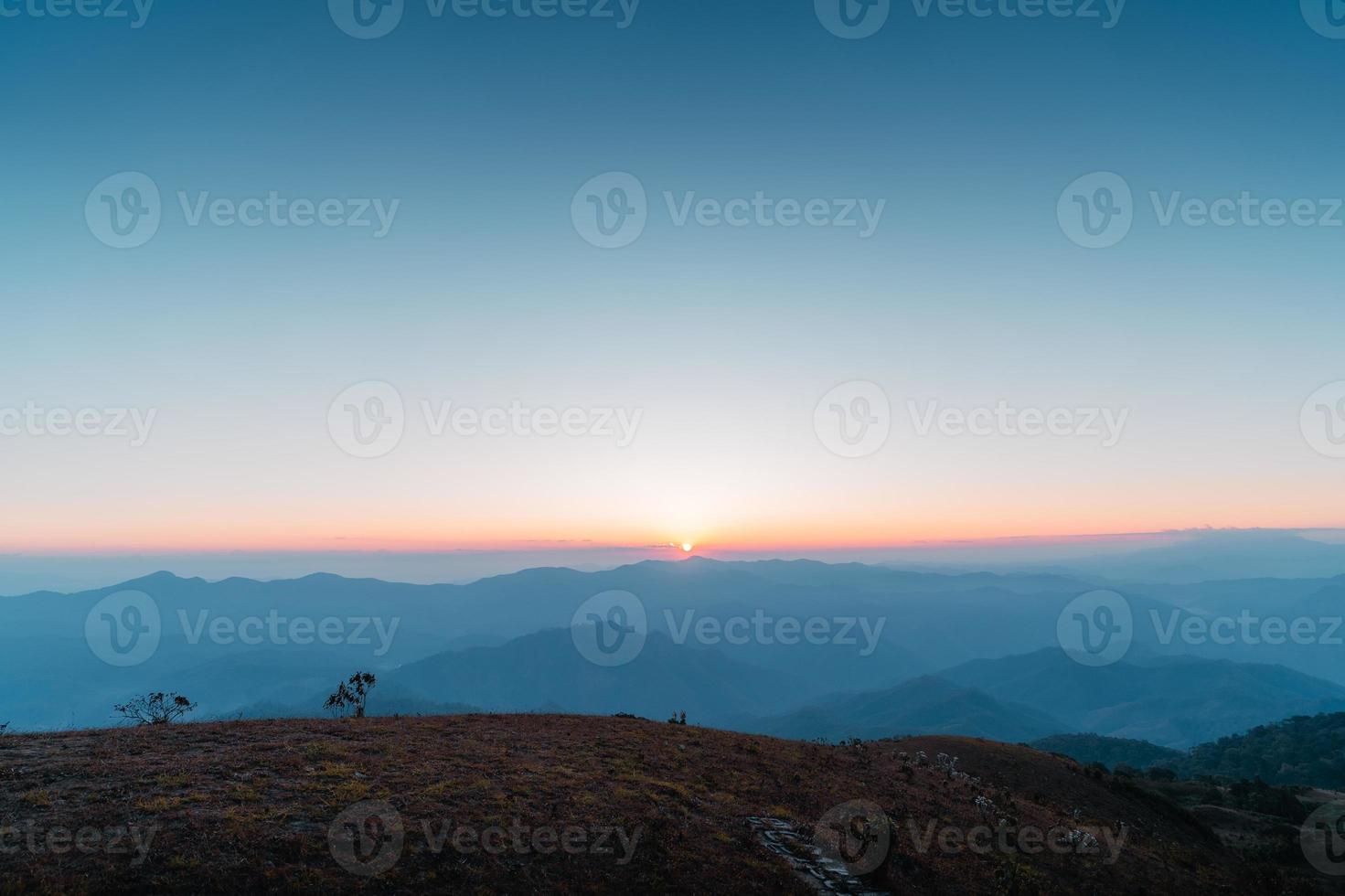 the sun rises on the mountain in summer photo