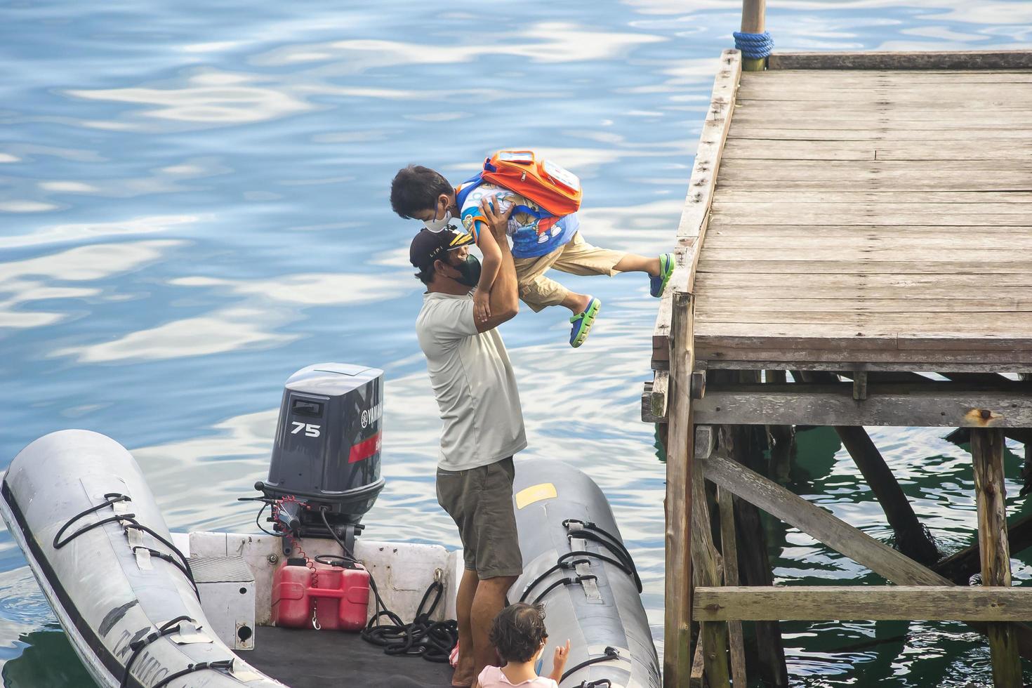 a father is preparing crossing transportation for his family photo