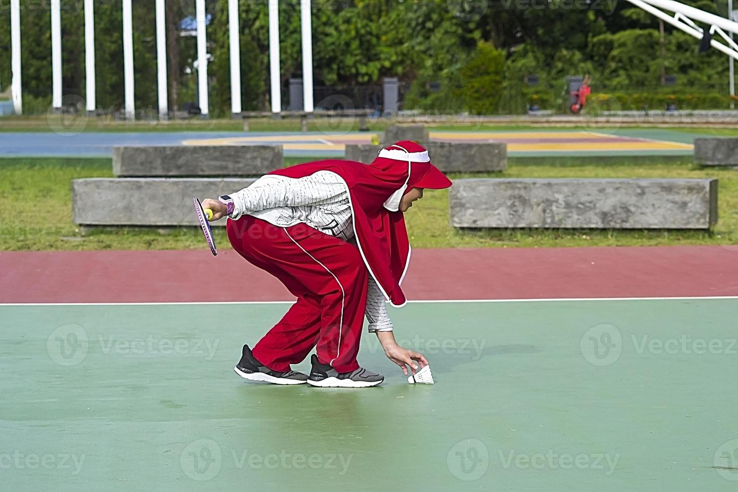 A muslim girl doing exercising at the public park photo