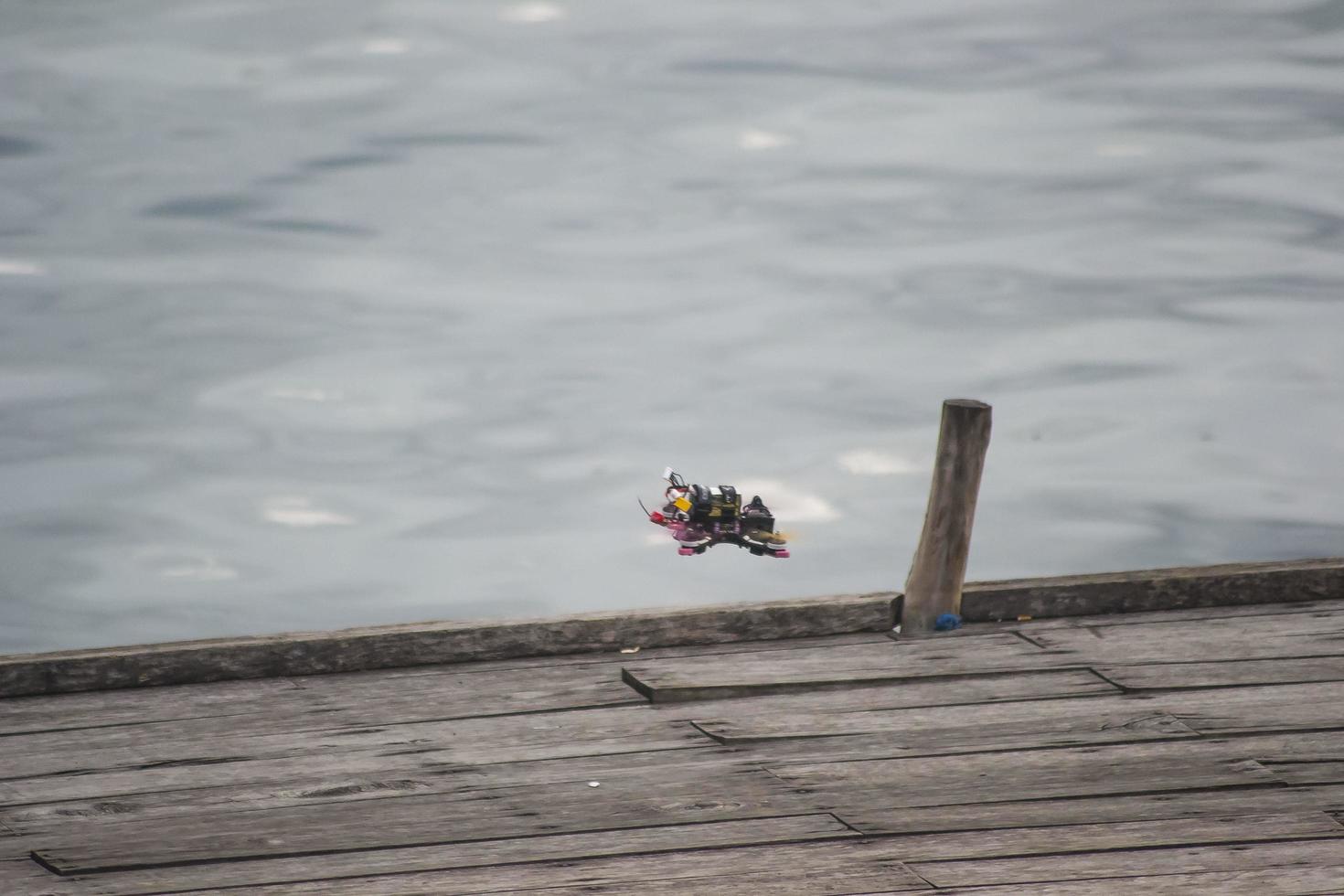 A drone flying over the wooden bridge photo