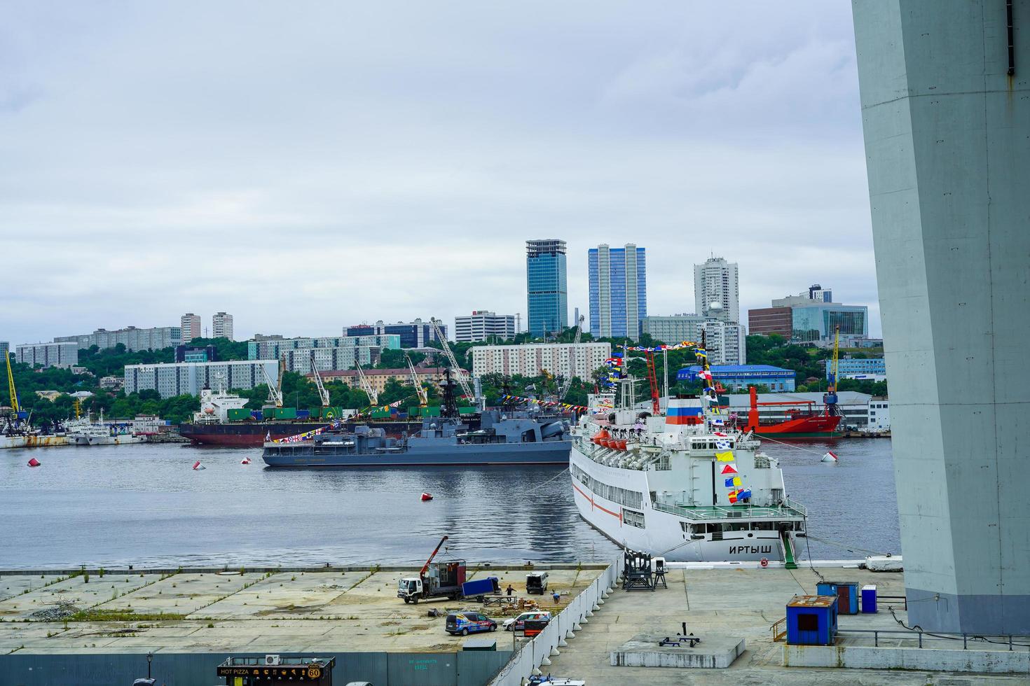 Vladivostok, Russia - July 26, 2020 -Warships on the background of the urban landscape. Day of the Navy. photo