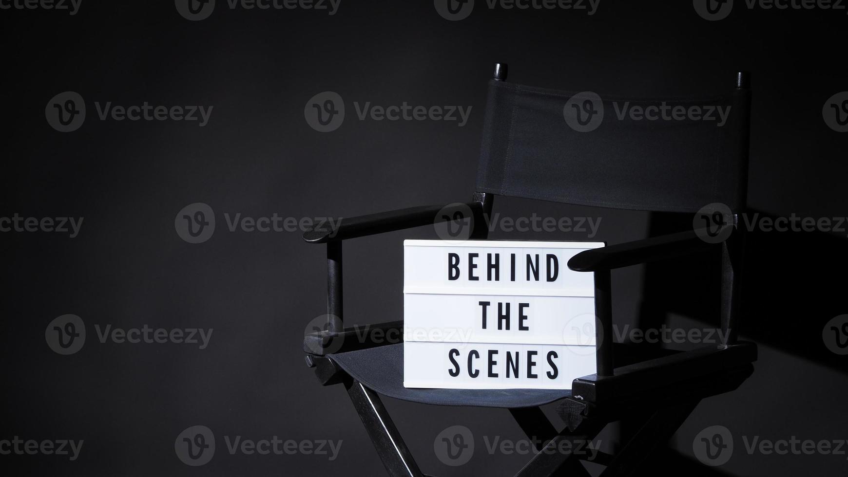 Director chair with behind the scene banner light box. photo