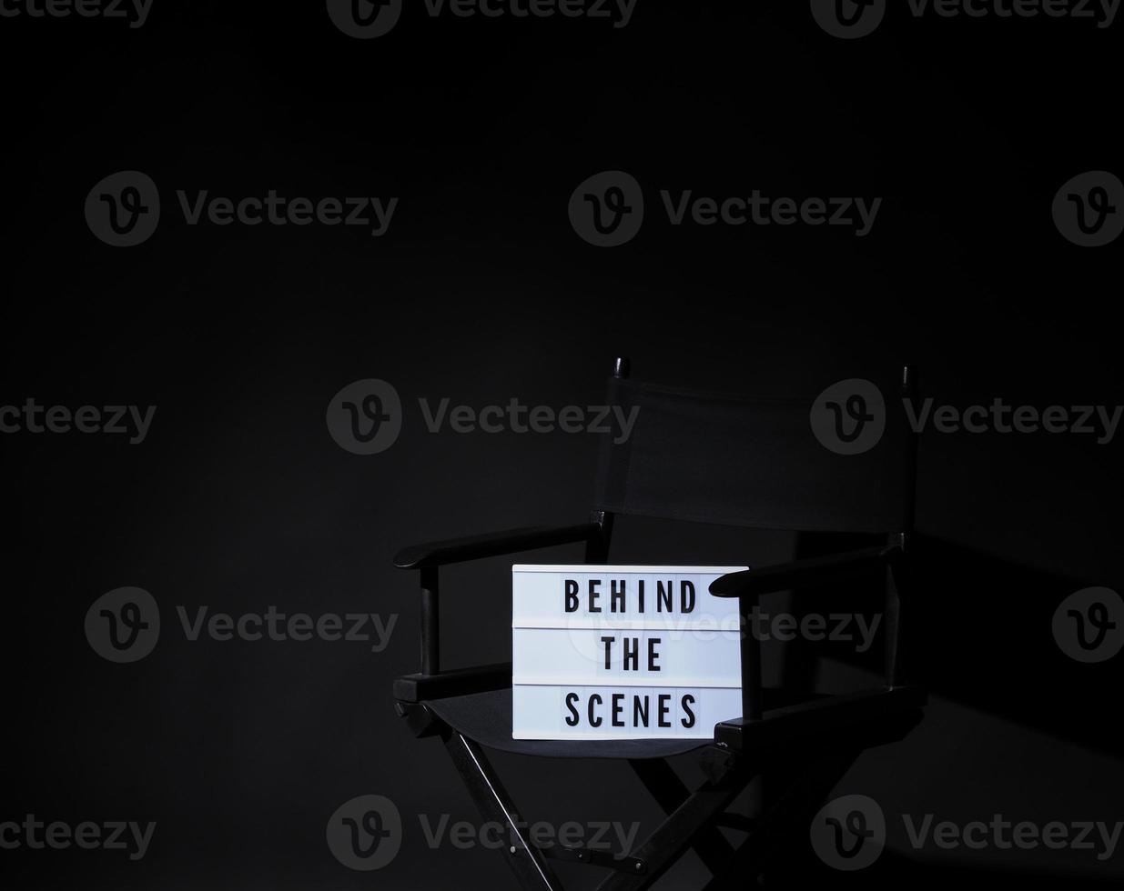 Director chair with behind the scene banner light box. photo