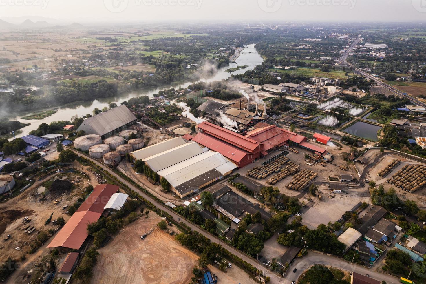 Sugar bioethanol translation factory working with steam from the chimney and sugarcane truck photo