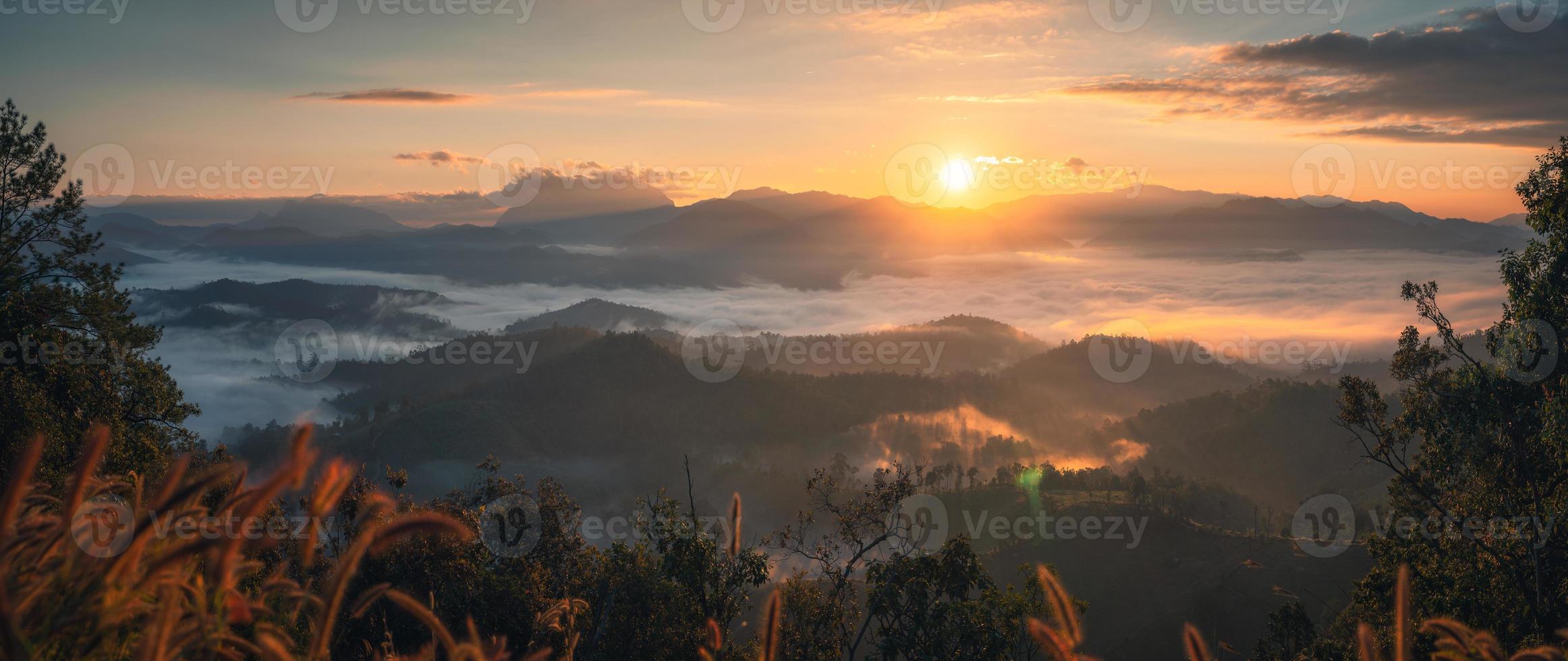 Sunrise shining over mountain range with foggy in tropical rainforest from Den TV viewpoint photo