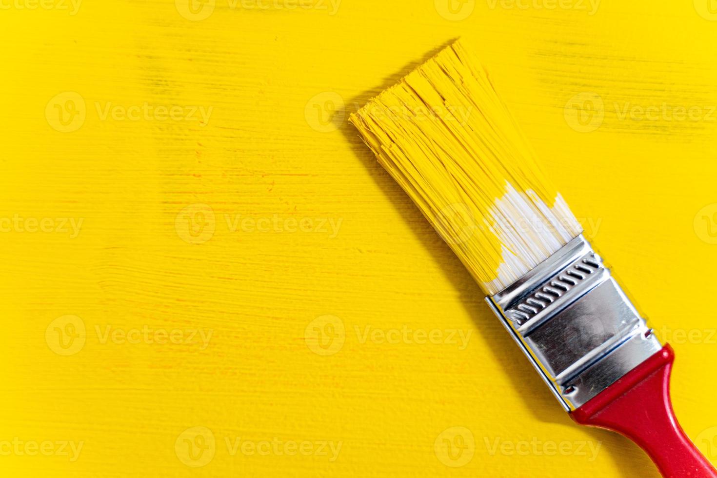 Brush on yellow textured background close-up photo