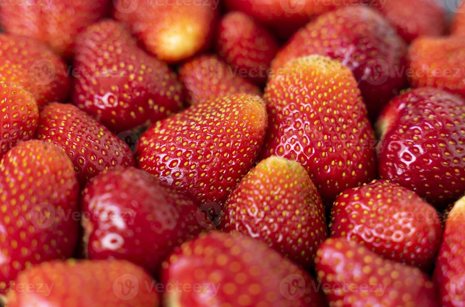 Background of red ripe strawberries close-up, top view. Food Fund. Full frame. photo