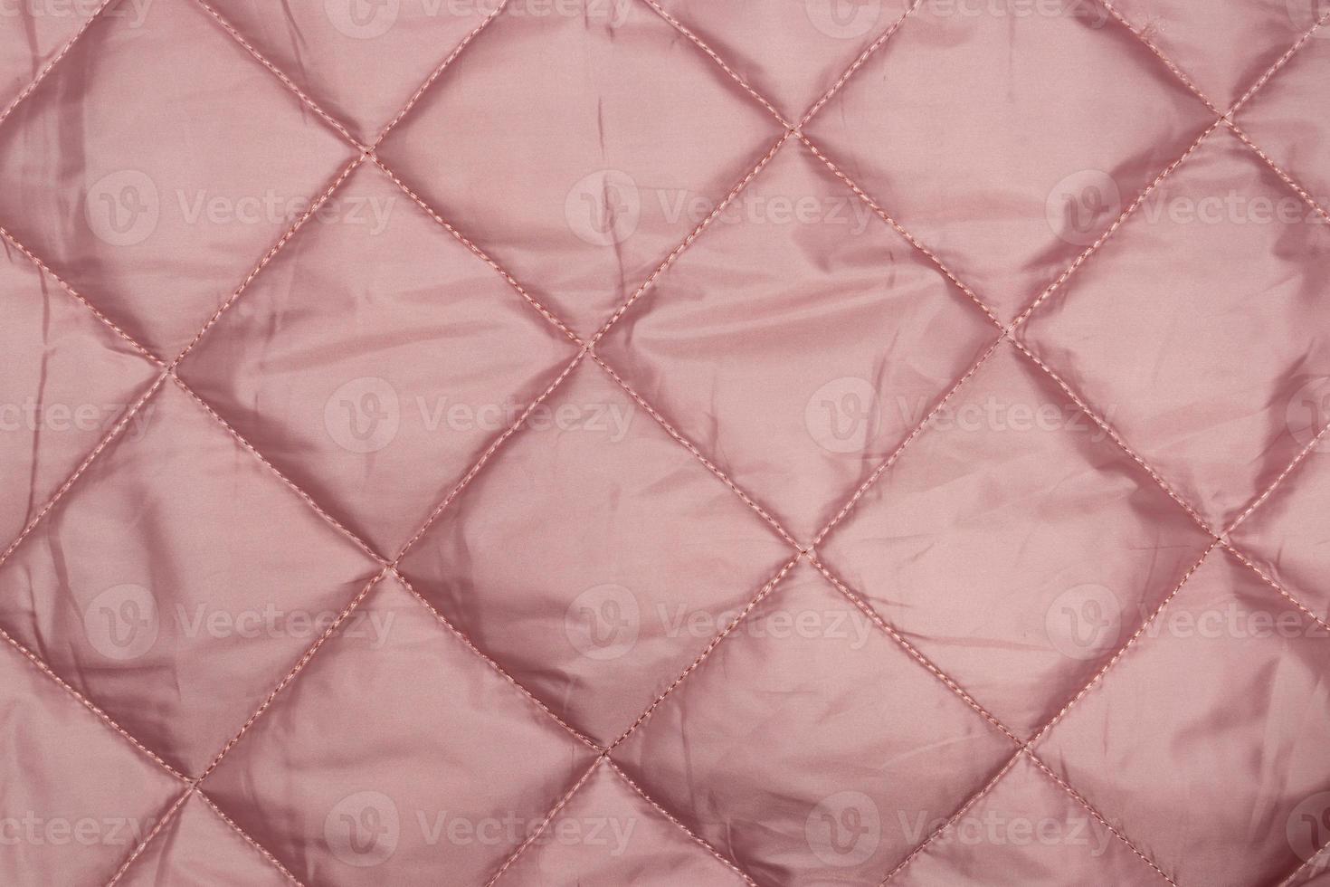 Photo of the texture of pink quilted fabric