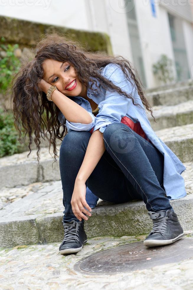 Attractive mixed woman in urban background wearing casual clothes photo