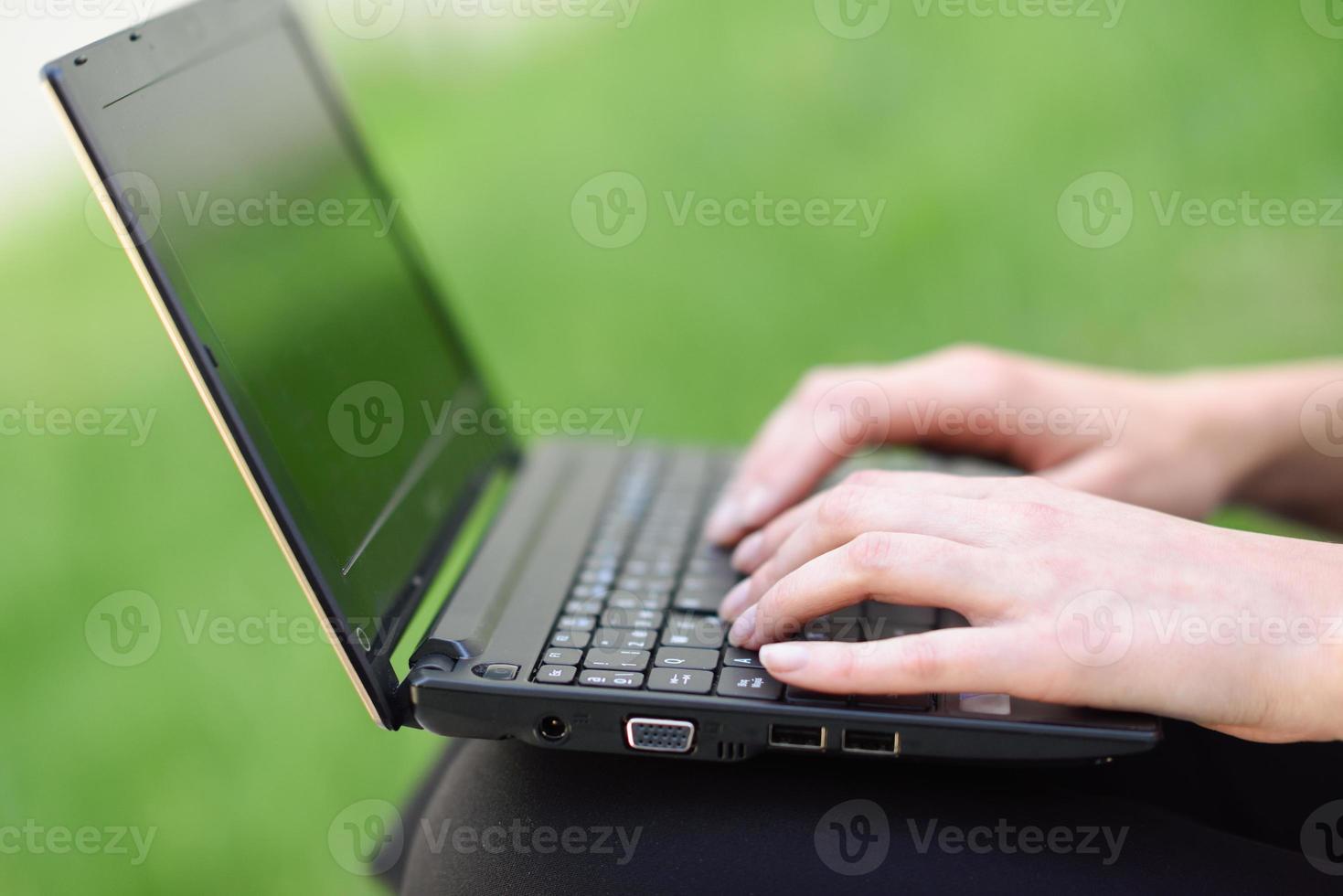 Woman hands typing on laptop computer keyboard. photo