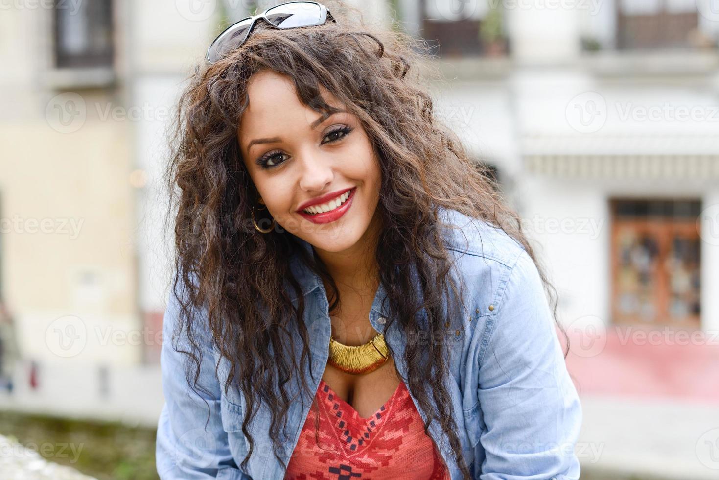 Attractive mixed woman in urban background wearing casual clothes photo