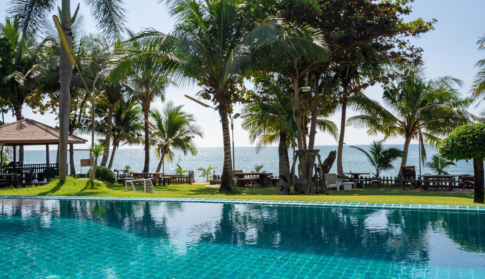 Part of swimming pool with background of tropical sea. photo