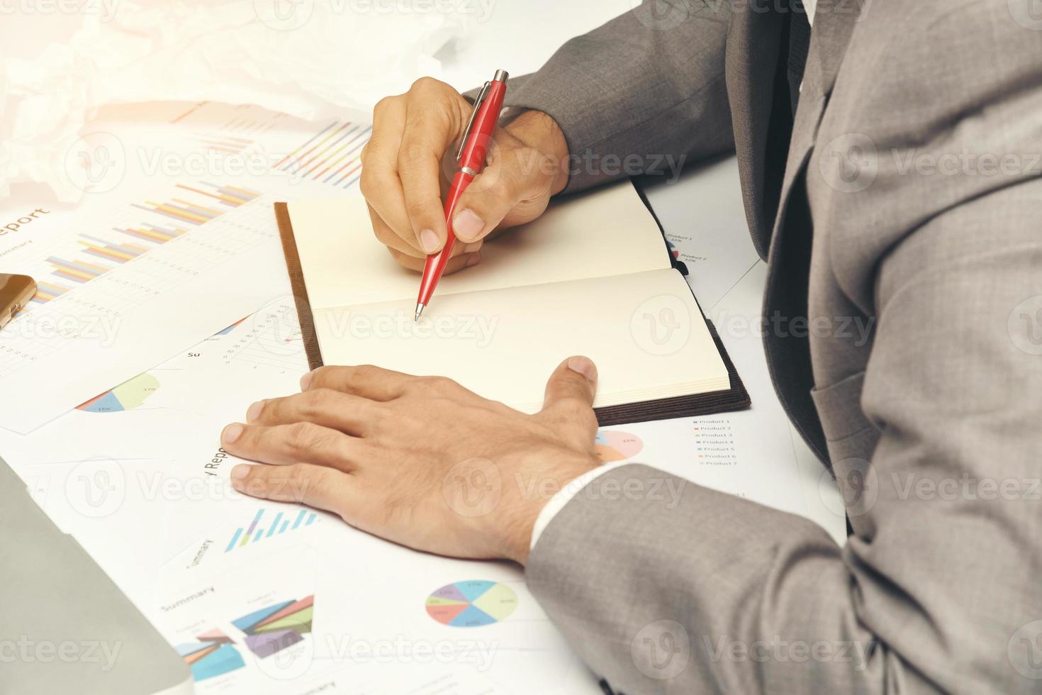 business man sitting writing text note and use red pen on work table at office photo