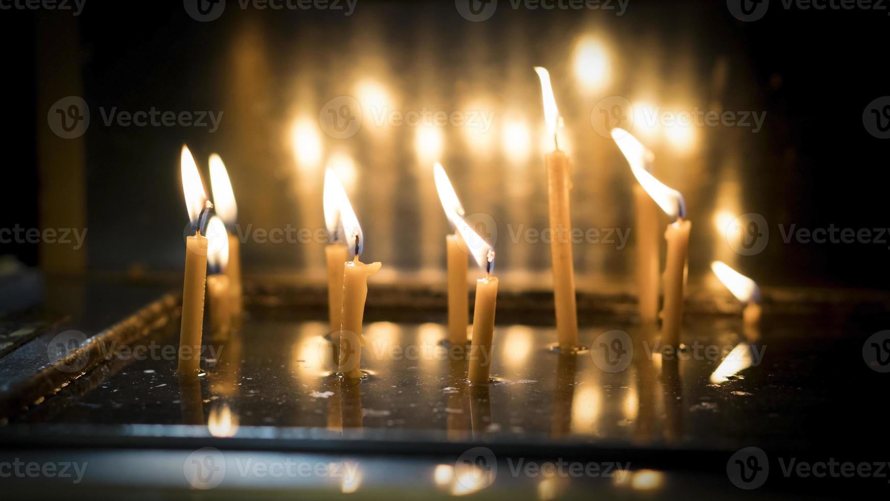 Wax memorial candles burning in the church for the mourning Christian people who lost their family photo