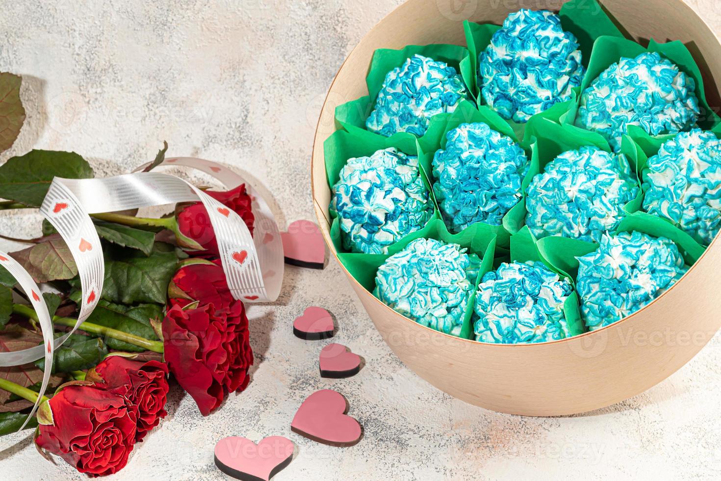 Handmade marshmallows in wooden packages on a light background with flowers. The concept of the holidays Women's Day and Valentine's Day. photo