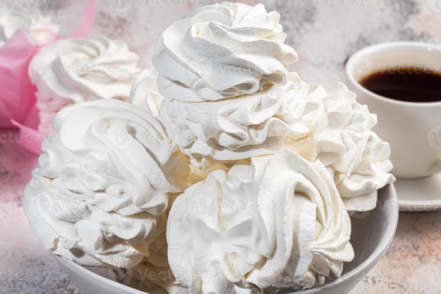 Handmade marshmallows on a light background in the form of roses, hydrangeas and tulips. There are flowers nearby. Women's day, Valentine's day. photo