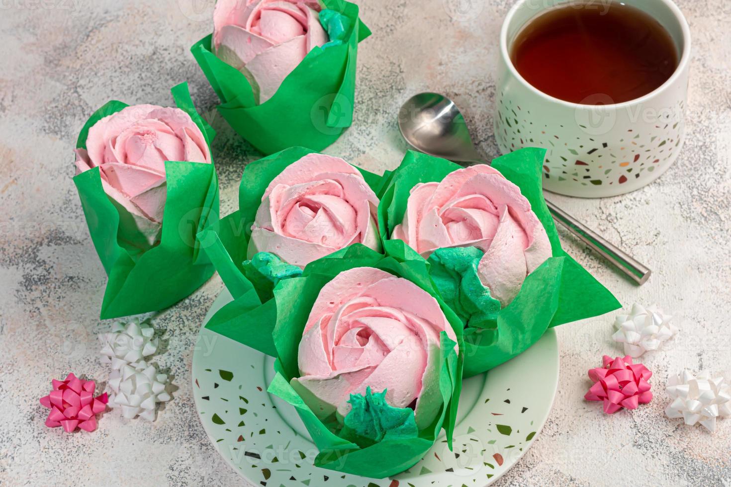 Handmade marshmallows on a light background in the form of roses, hydrangeas and tulips. There are flowers nearby. Women's day, Valentine's day. photo