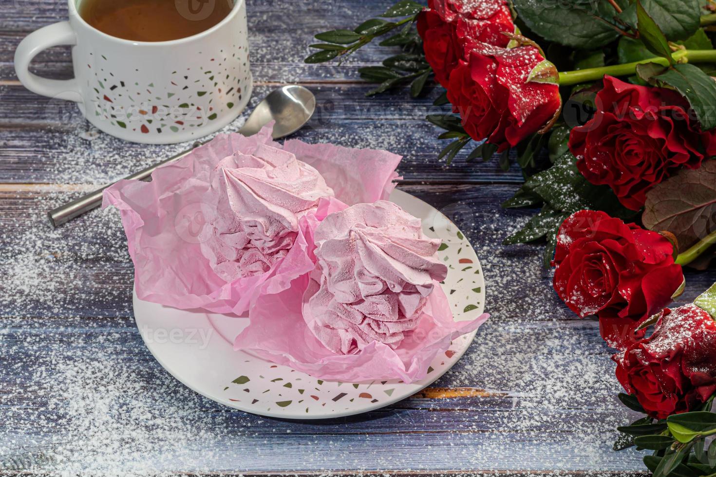 Handmade marshmallows on a light background in the form of roses, hydrangeas and tulips. There are flowers nearby. Women's day, Valentine's day. photo