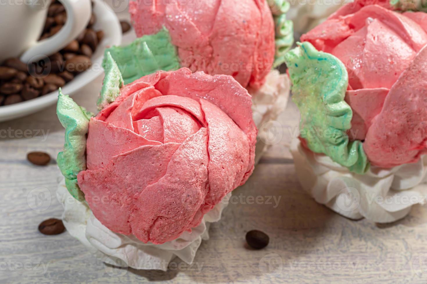 Handmade marshmallows on a light background in the form of roses, hydrangeas and tulips. There are flowers nearby. Women's day, Valentine's day. photo