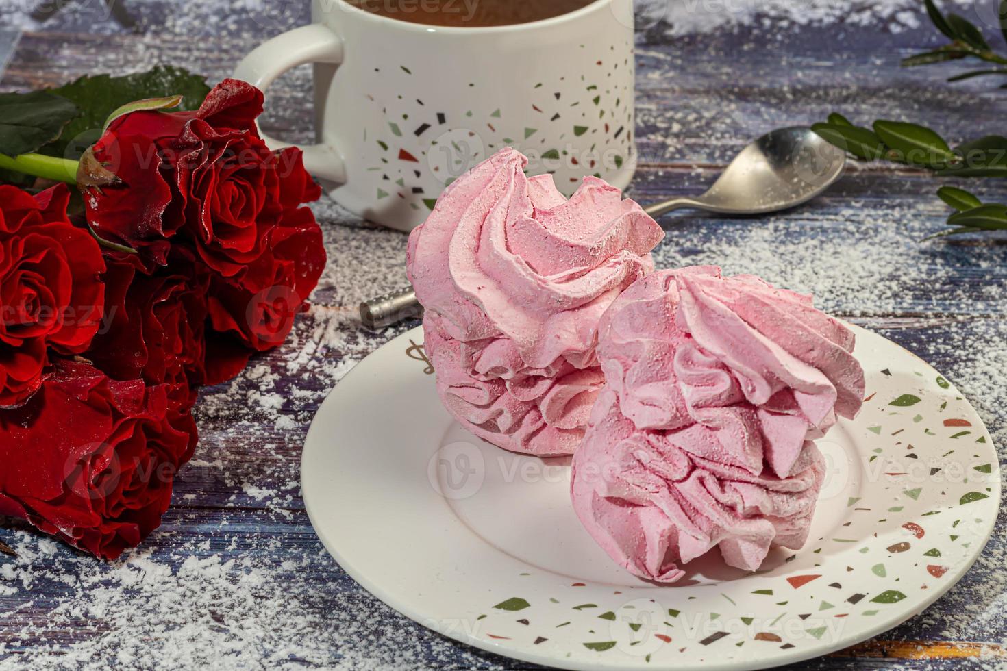 Handmade marshmallows on a light background in the form of roses, hydrangeas and tulips. There are flowers nearby. Women's day, Valentine's day. photo
