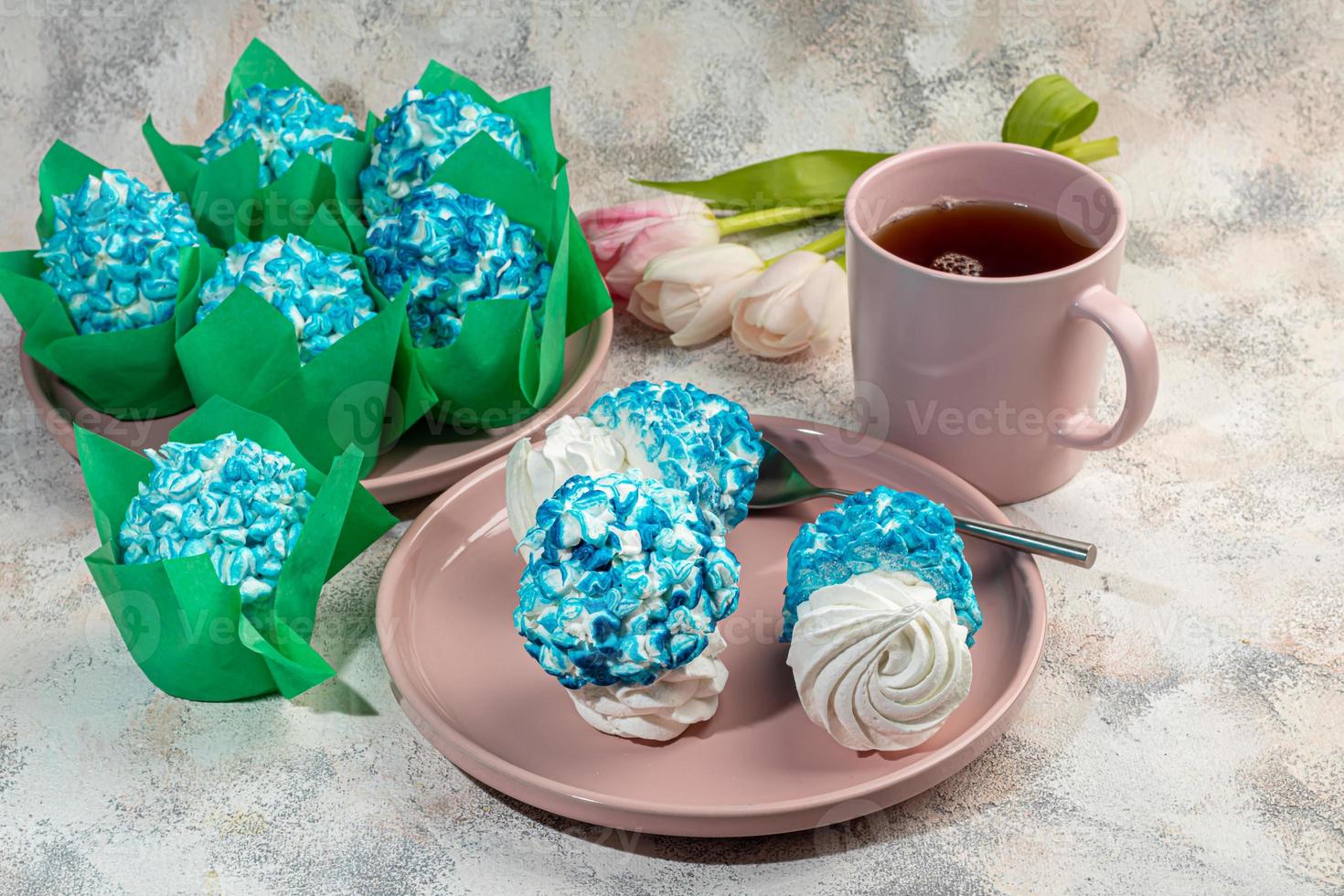 Handmade marshmallows on a light background in the form of roses, hydrangeas and tulips. There are flowers nearby. Women's day, Valentine's day. photo